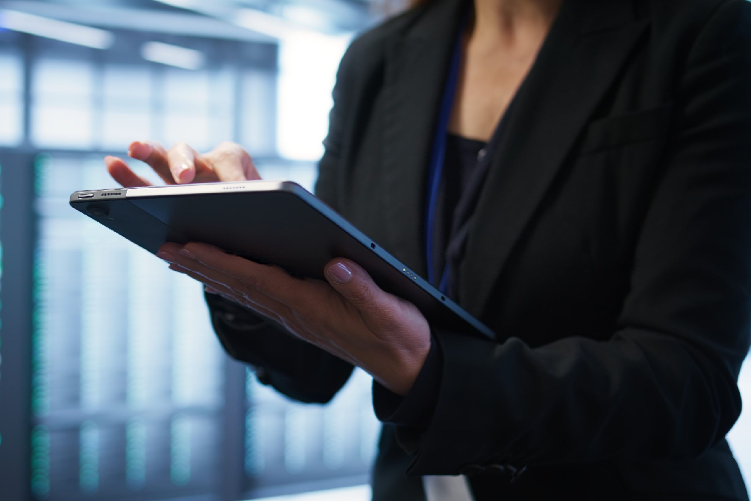 Close up shot of person in server room optimizing data center gear